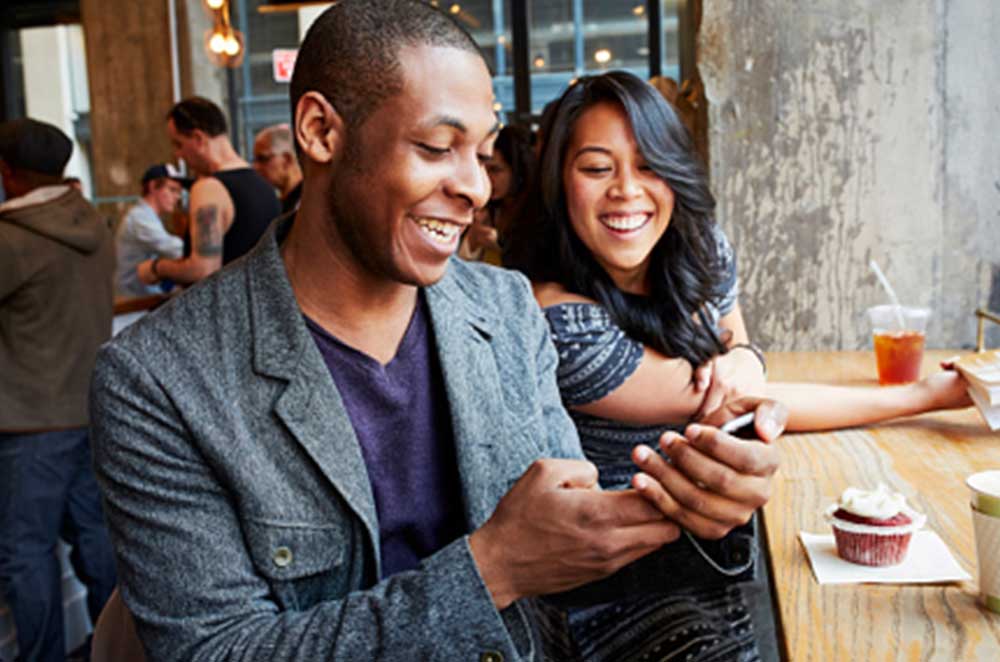 Couple Laughing At Cell Phone